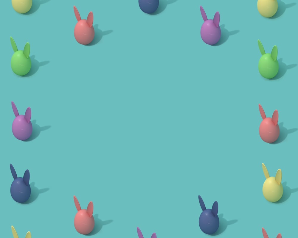 a group of different colored bunnies sitting on top of a blue surface