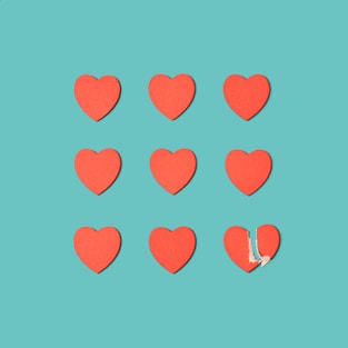a group of red hearts cut out of paper