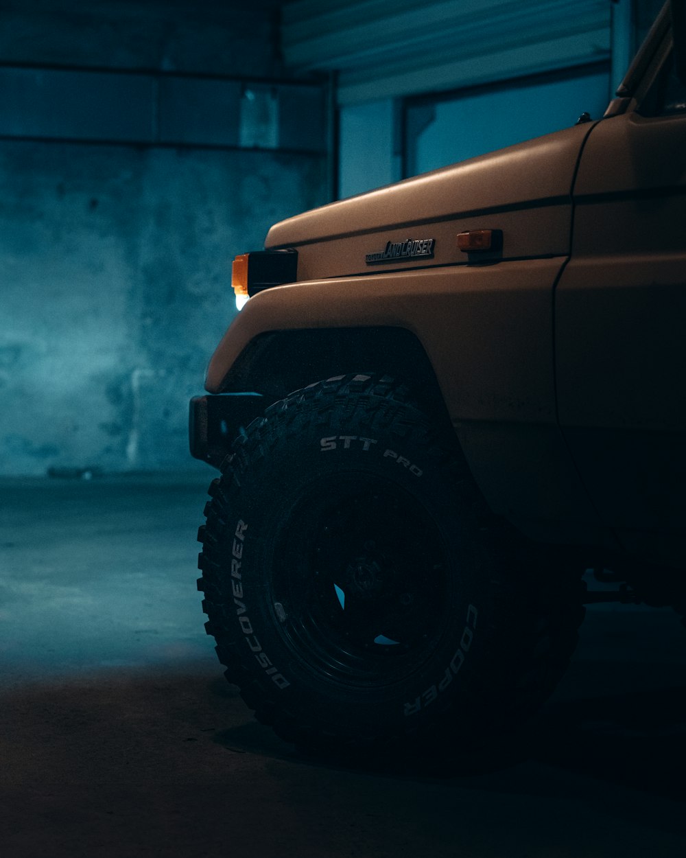 a yellow truck parked in a garage next to a wall