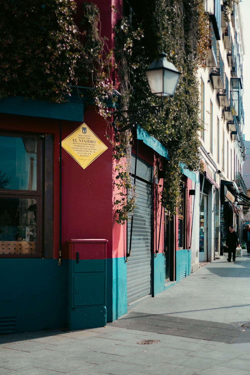 a red and blue building on a city street