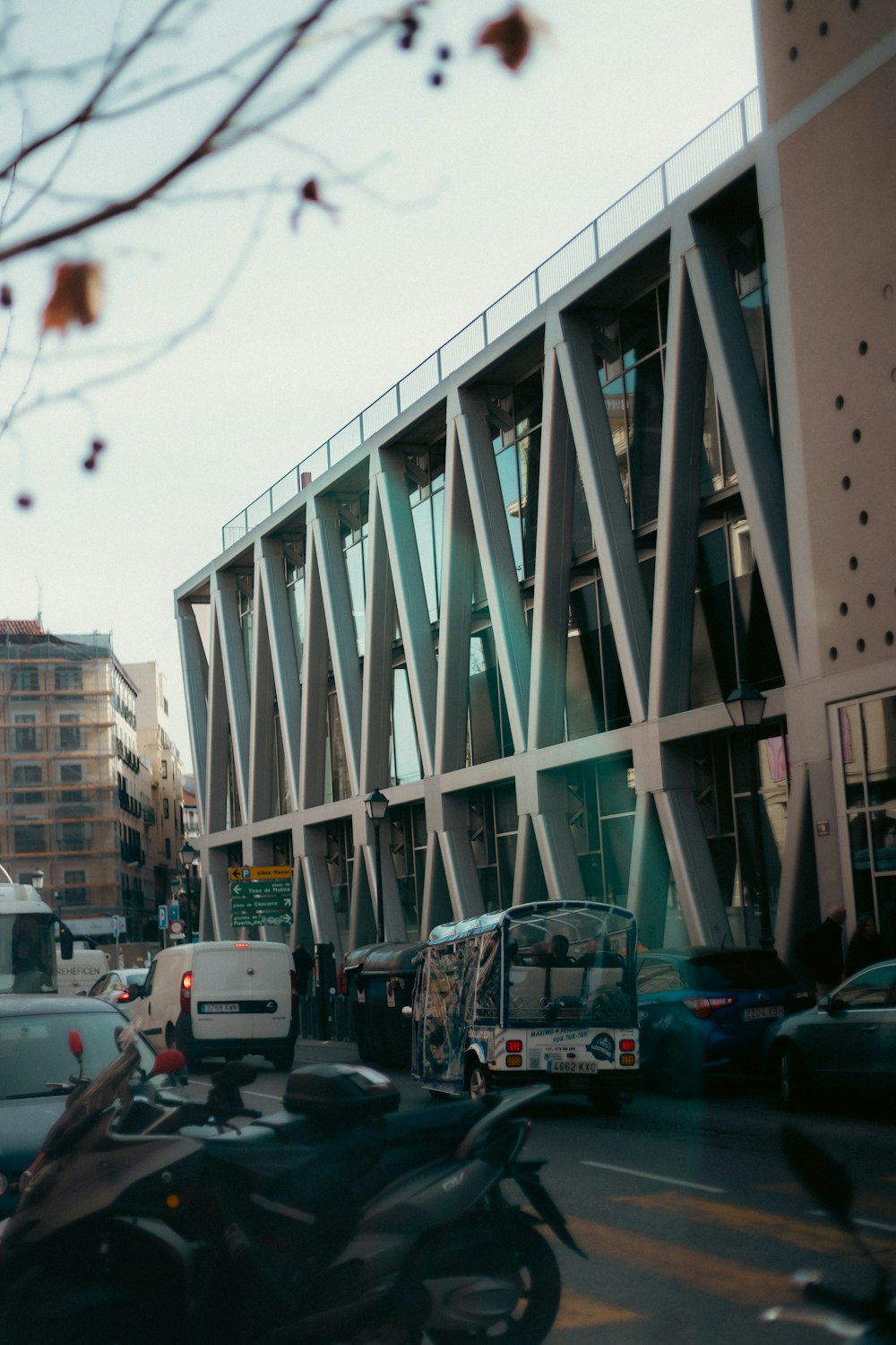 a city street filled with lots of traffic next to tall buildings