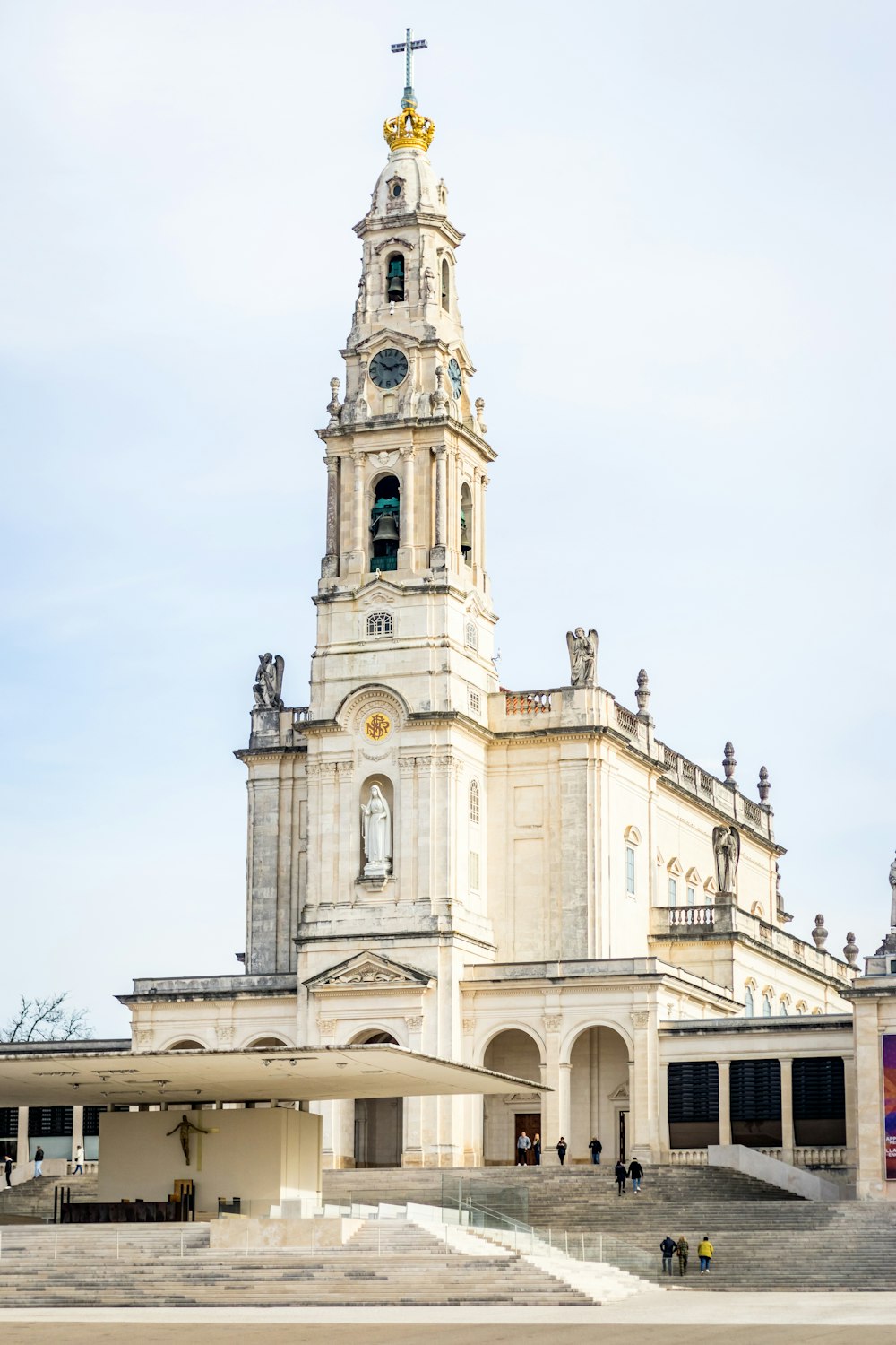 a tall white building with a clock tower