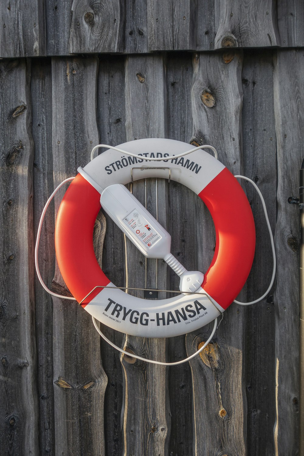 a life preserver attached to a wooden fence