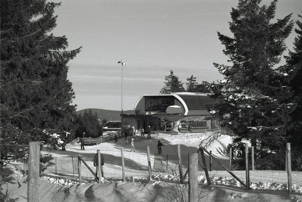 a black and white photo of a barn in the snow