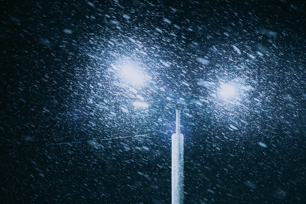 a street light in the snow at night