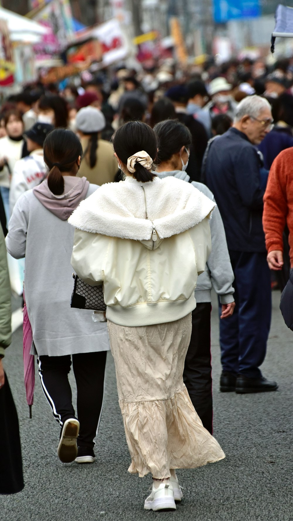 a group of people walking down a street