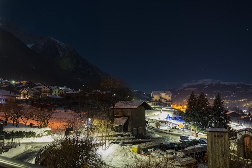 a night view of a town with a mountain in the background