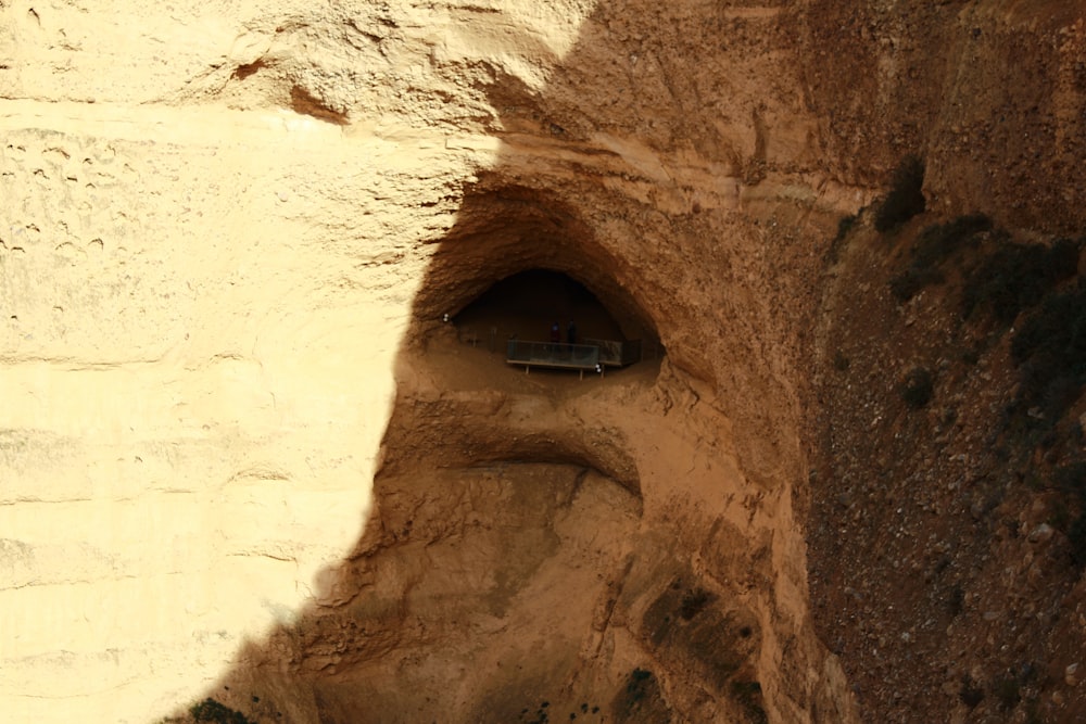 a car is parked in a cave on the side of a mountain