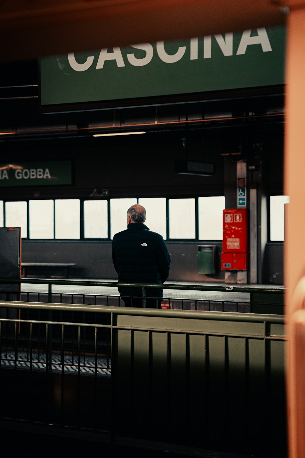a man is waiting at a train station
