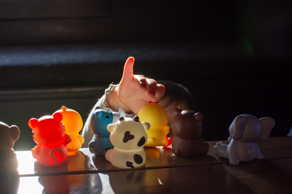 a baby reaching for a toy on a table