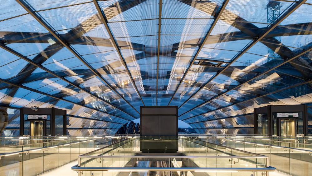 a glass ceiling in a building with a sky background