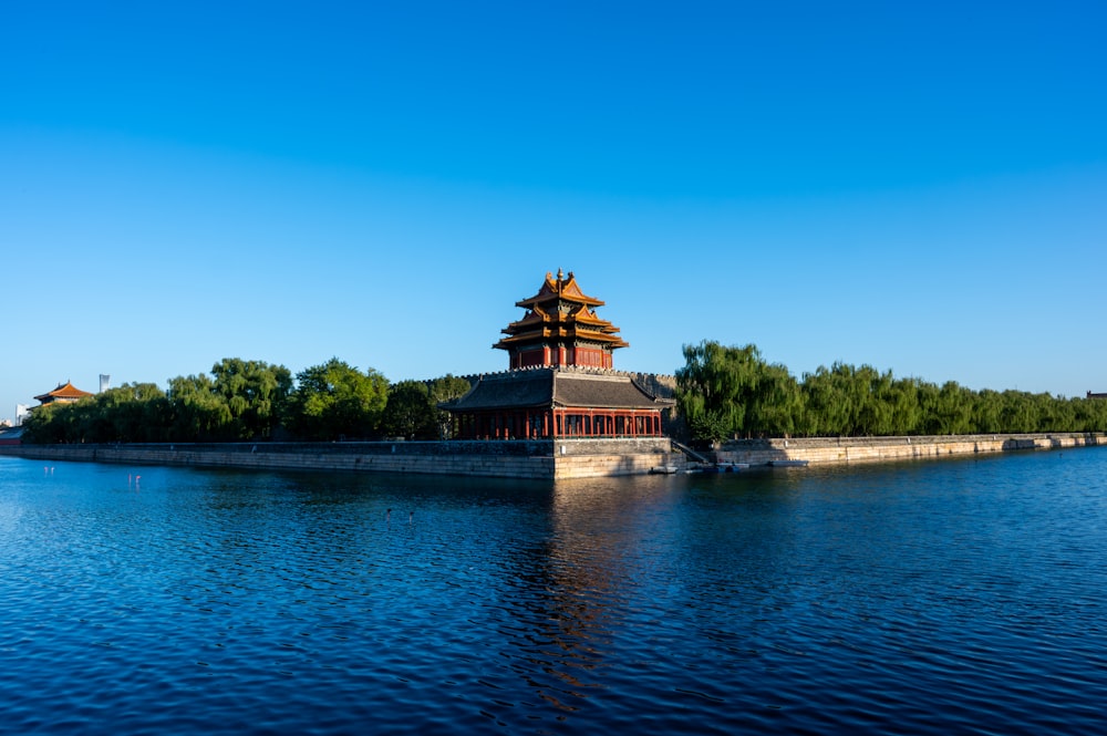 a building on a small island in the middle of a lake