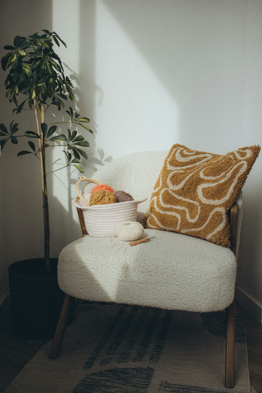 a white chair with a basket of fruit on it