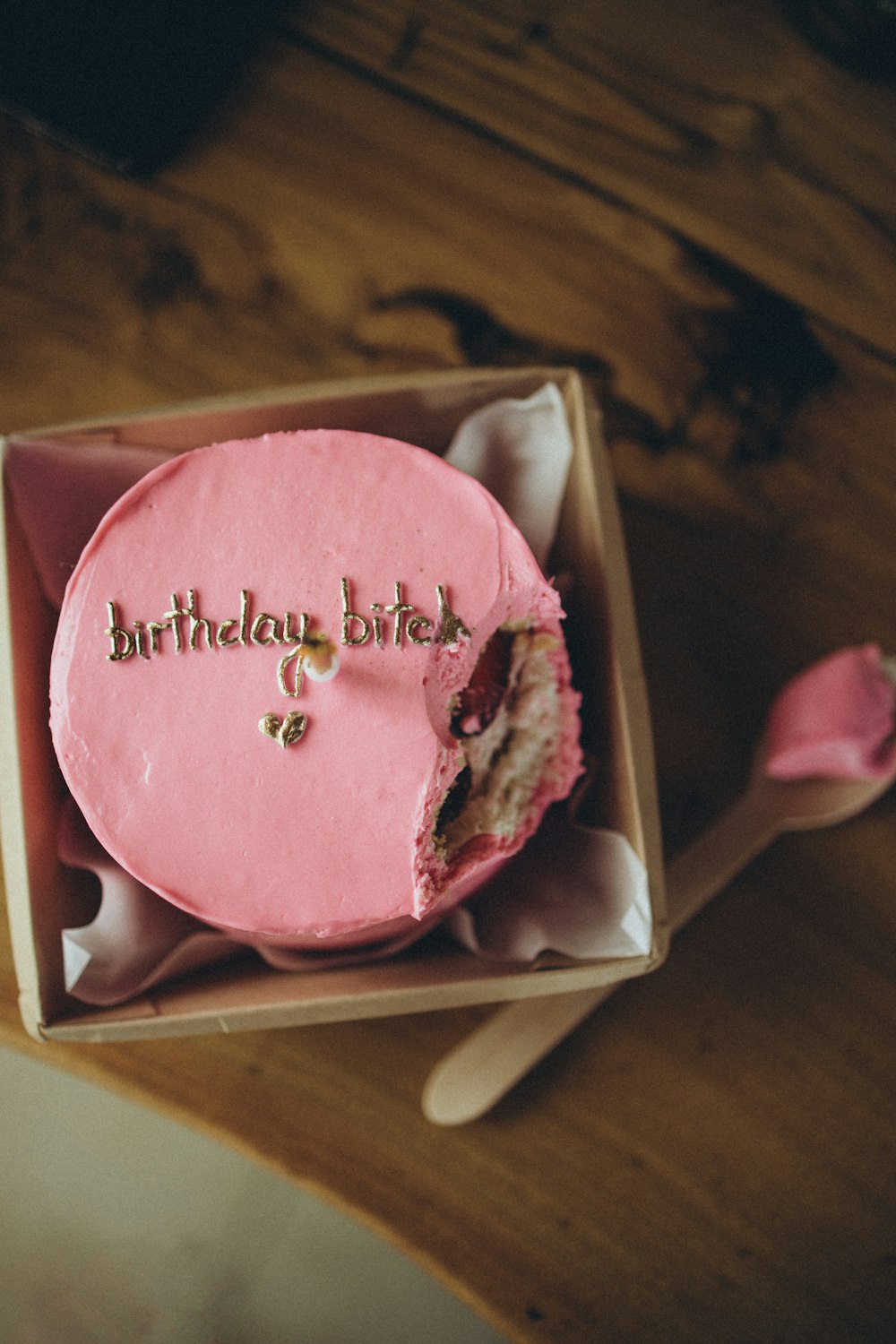 a pink birthday cake in a pink box