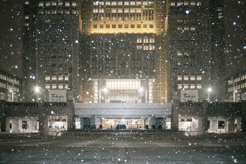 a large building with a lot of snow falling on it