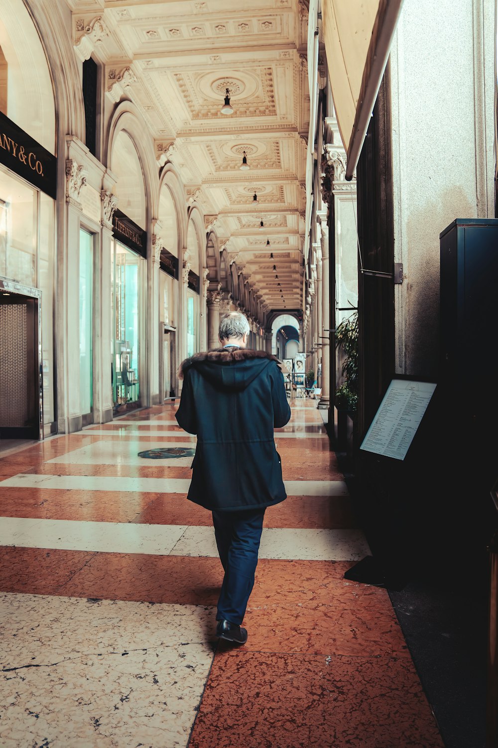 a man walking down a hallway in a building