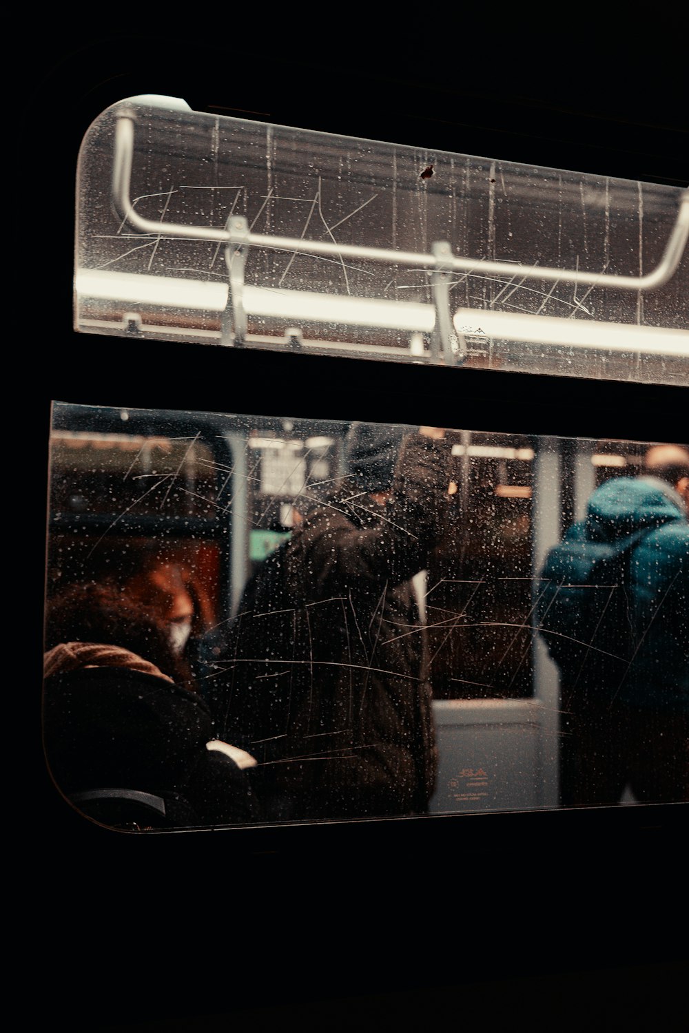 a couple of people standing on a train