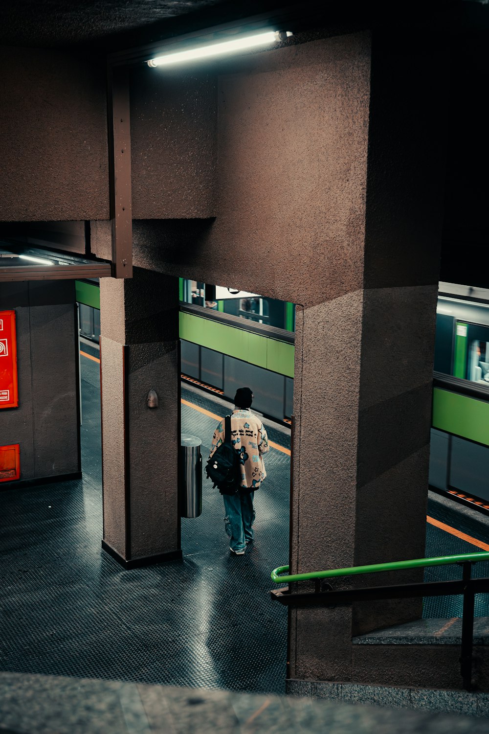 a person with a backpack walking through a subway station