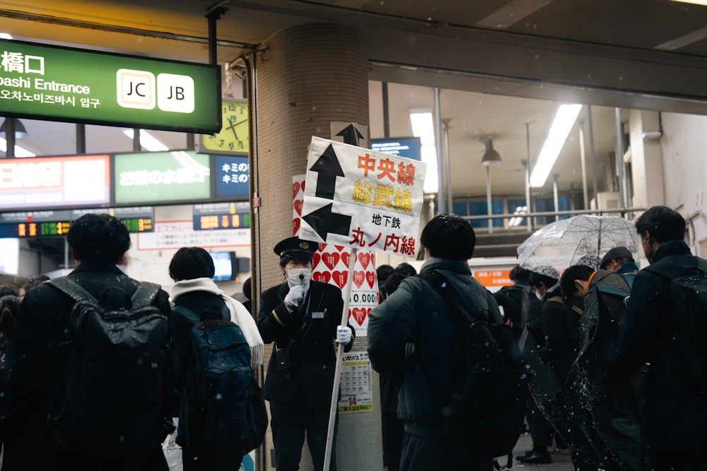 a group of people standing next to each other holding umbrellas