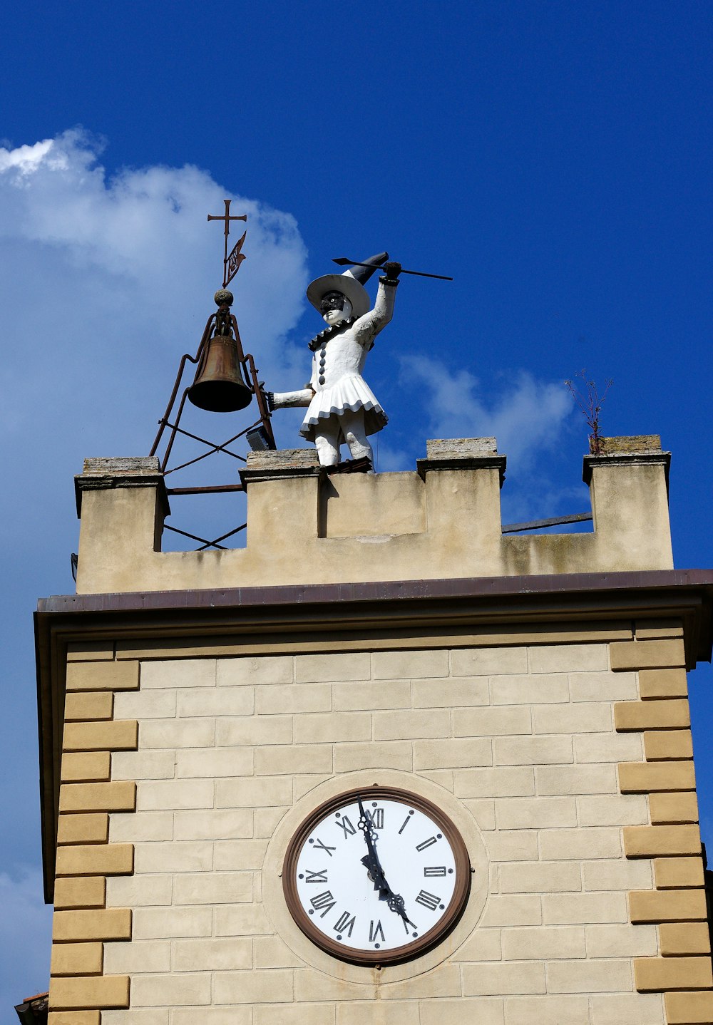 a clock tower with a statue of a woman on top of it
