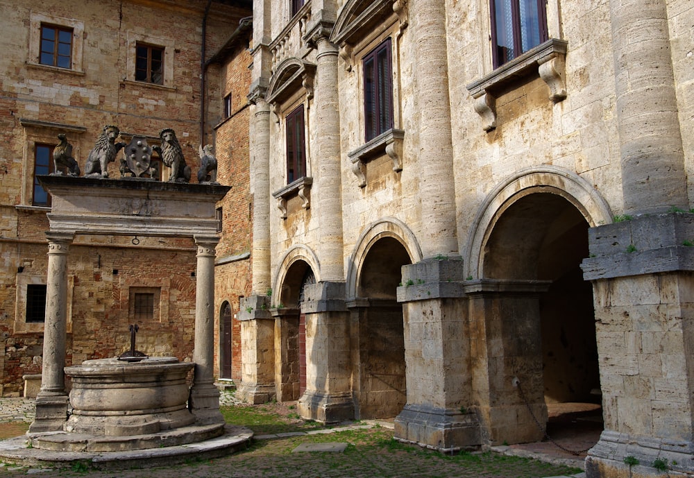 an old building with a fountain in front of it