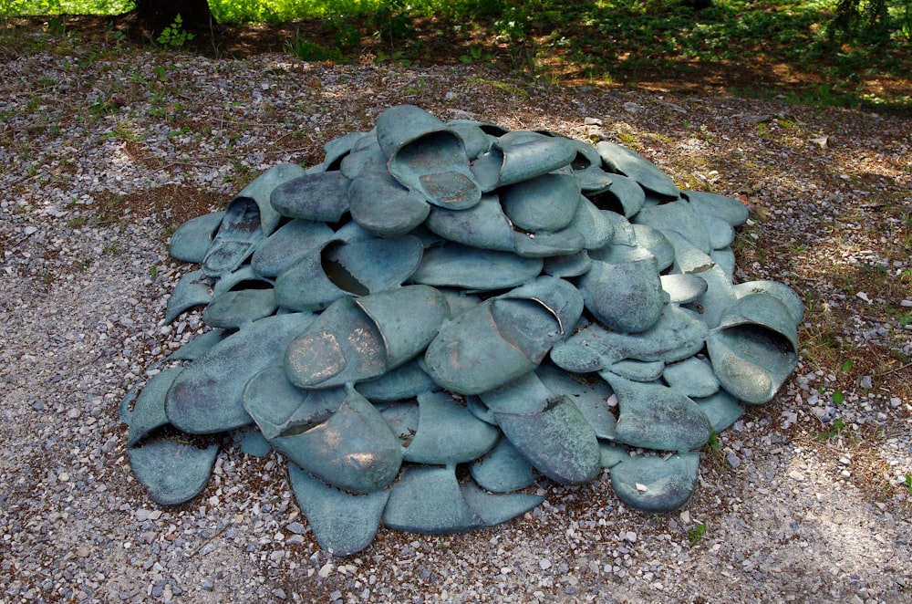 a pile of rocks sitting on top of a gravel field