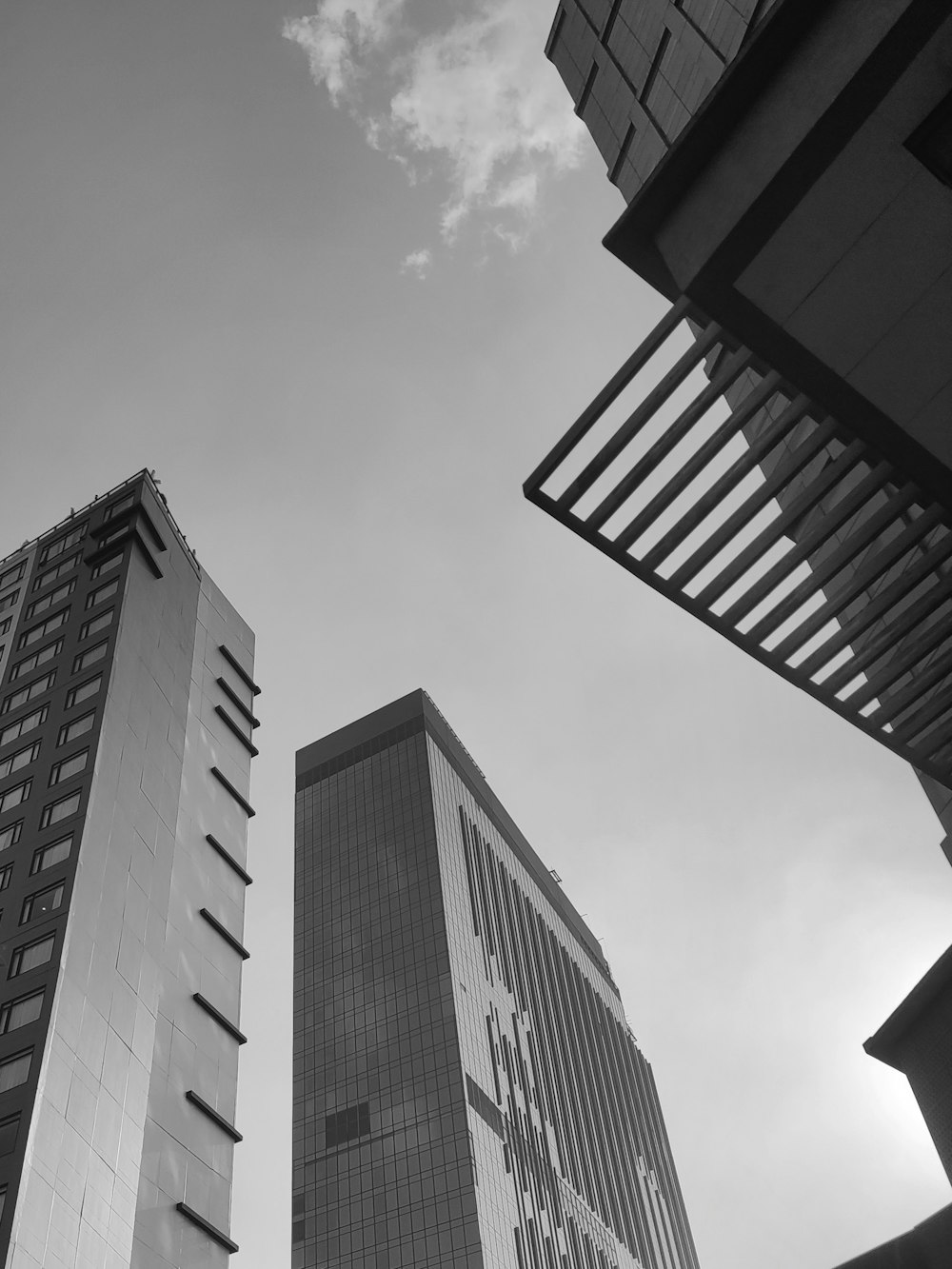 a black and white photo of two tall buildings