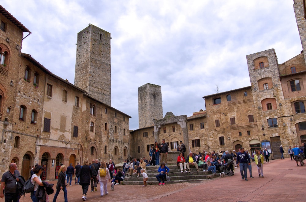 a group of people walking around a stone courtyard