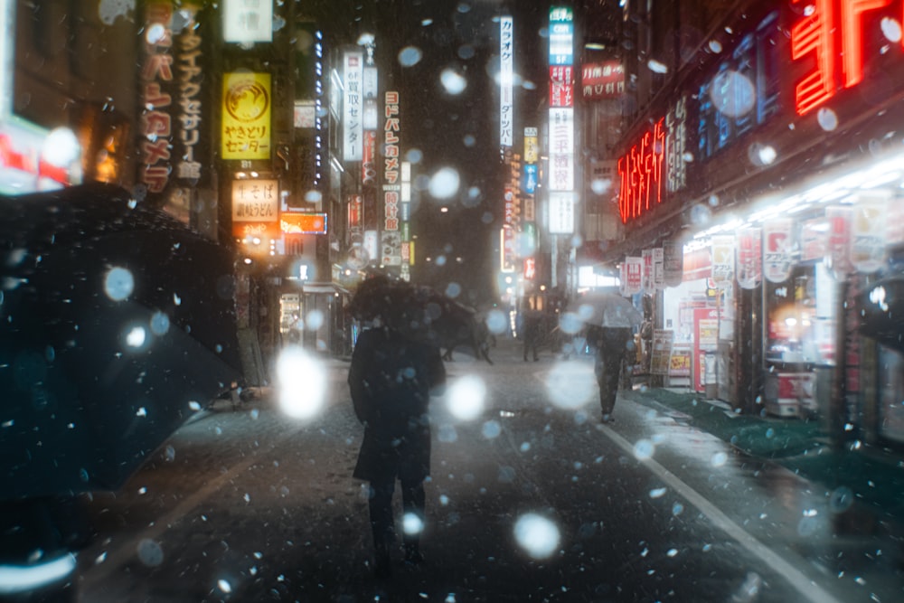 a person walking down a street holding an umbrella