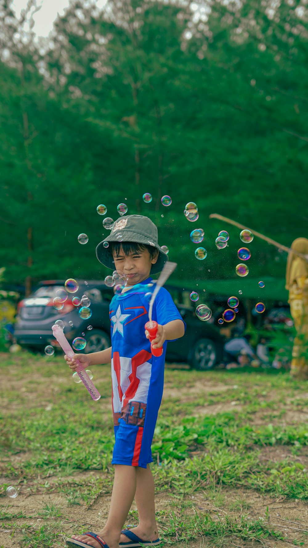 a young boy in a patriotic shirt is playing with soap bubbles