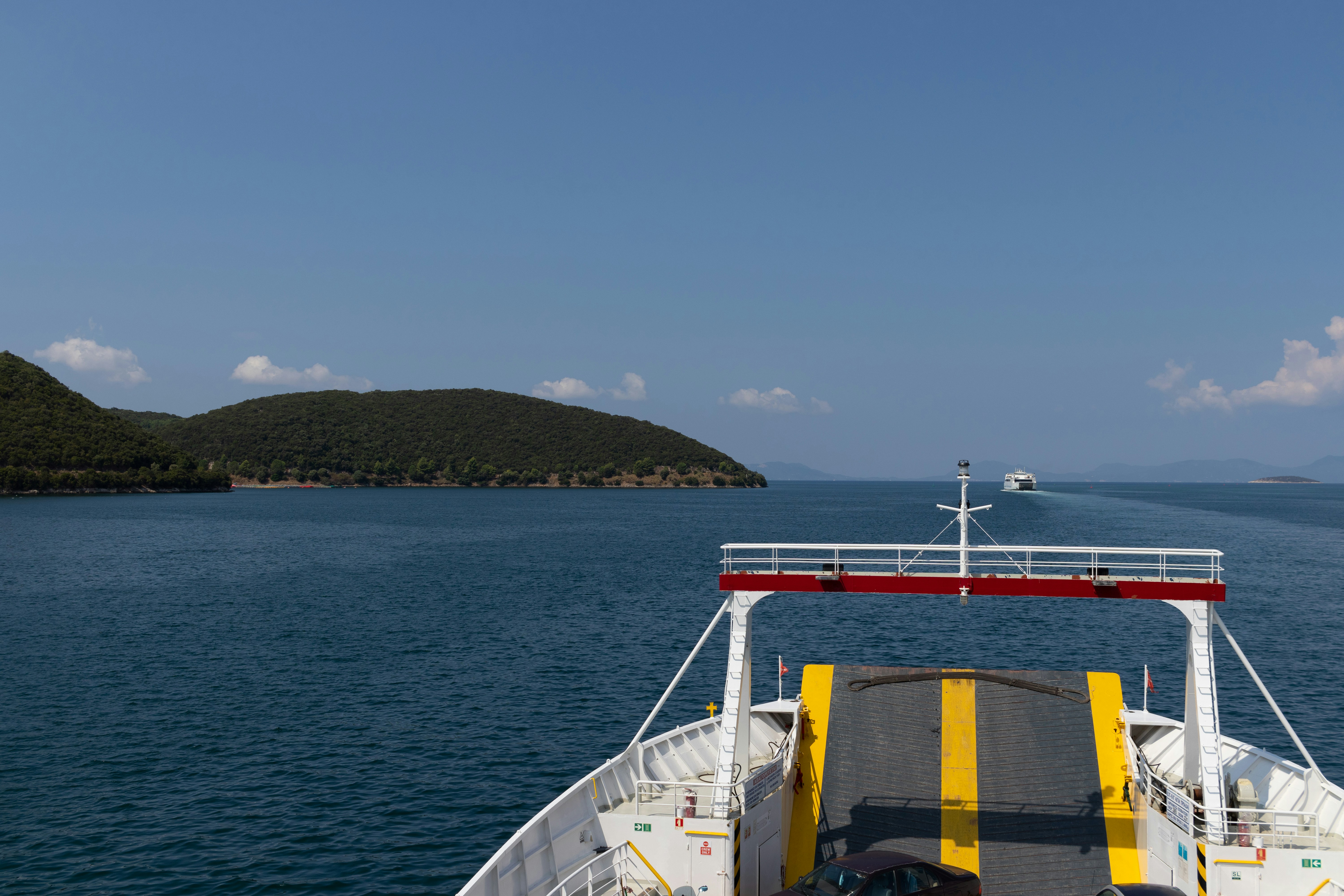 a car is parked on the deck of a boat