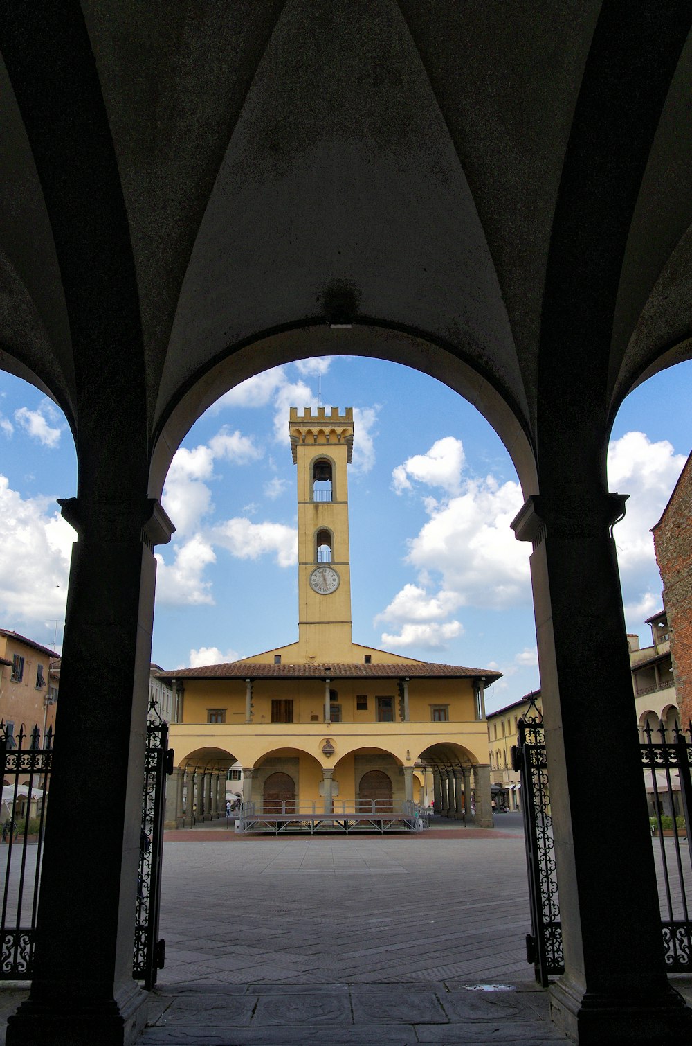 a clock tower is seen through an archway