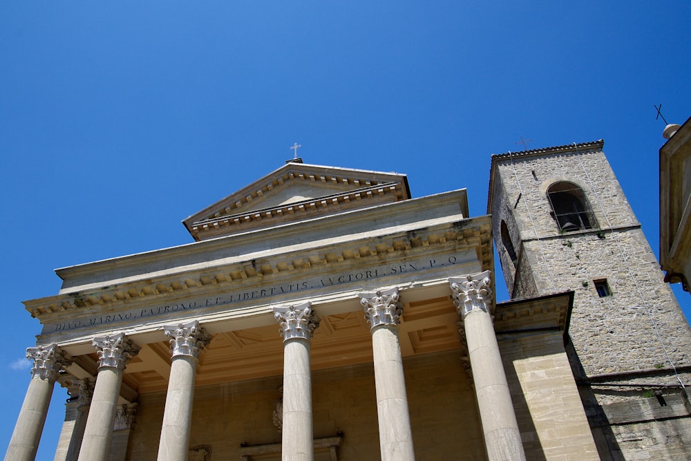 a tall building with columns and a clock tower