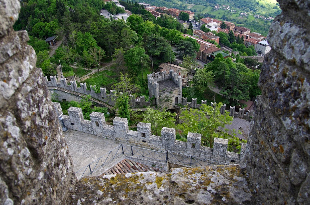 a view of a castle through a hole in a wall