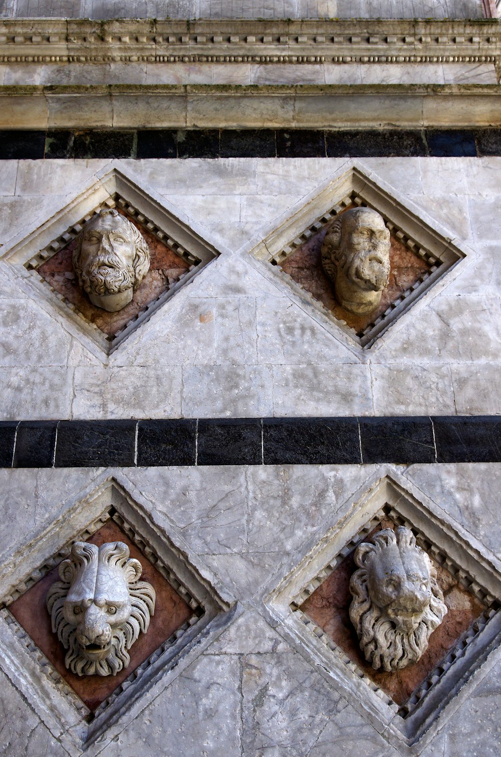 a close up of a building with four faces on it