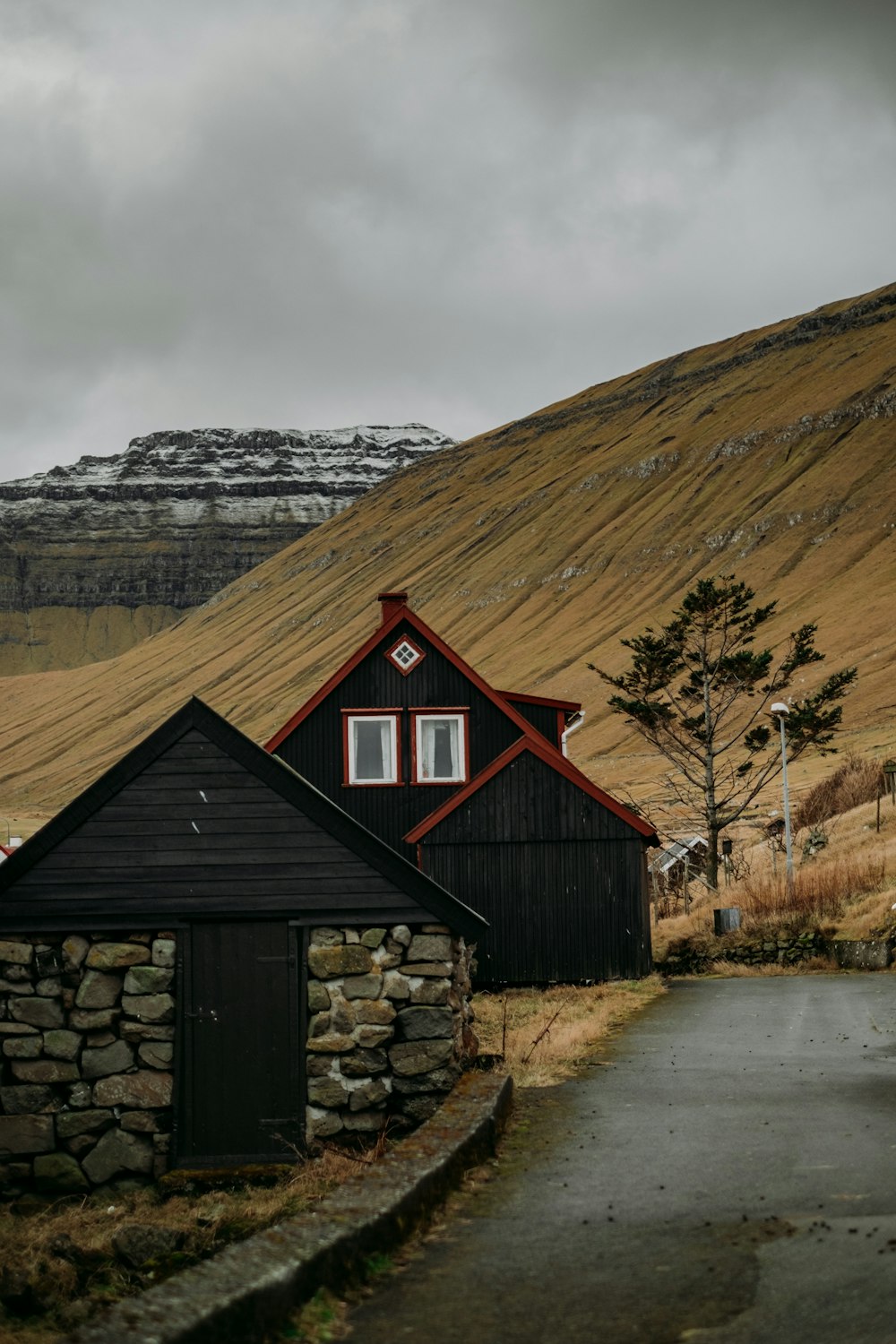 a black house with a mountain in the background