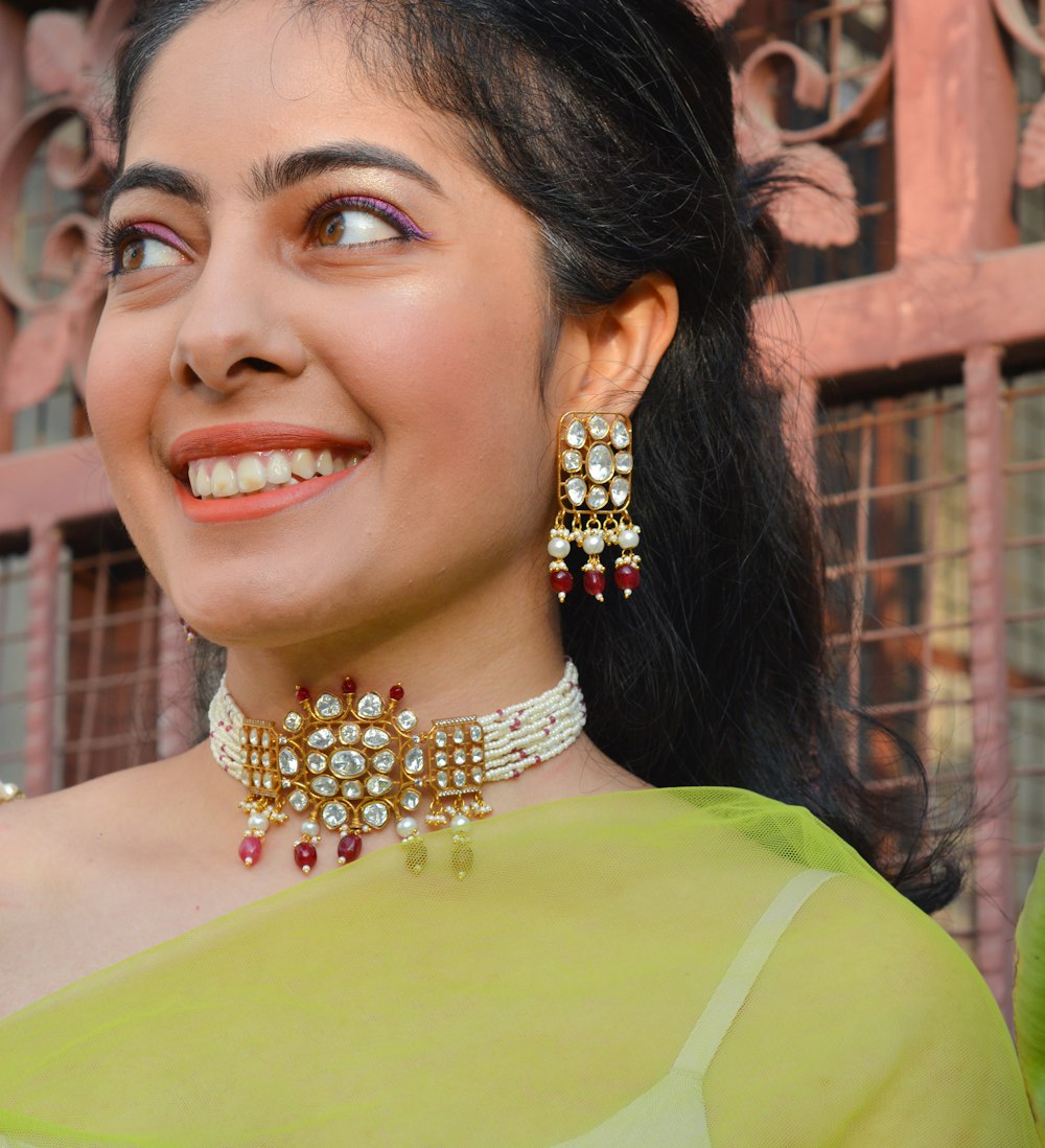 a woman in a green sari smiling