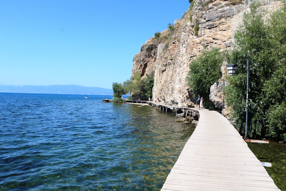 a wooden dock sitting next to a large body of water