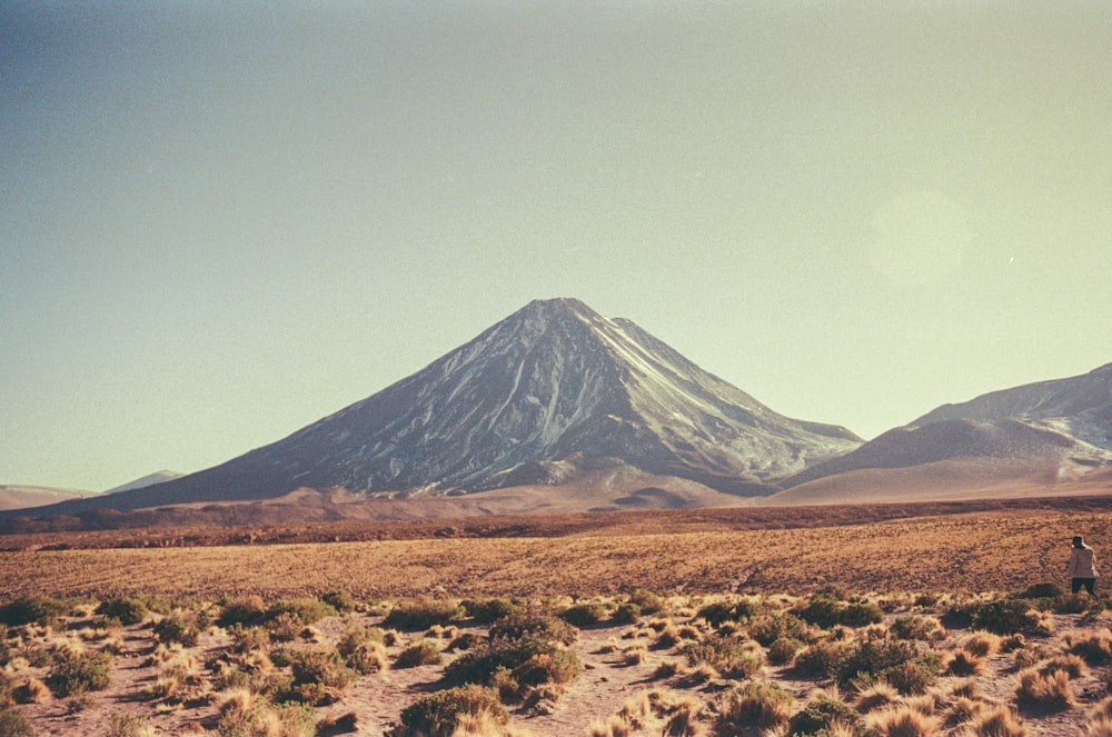 a large mountain in the middle of a desert