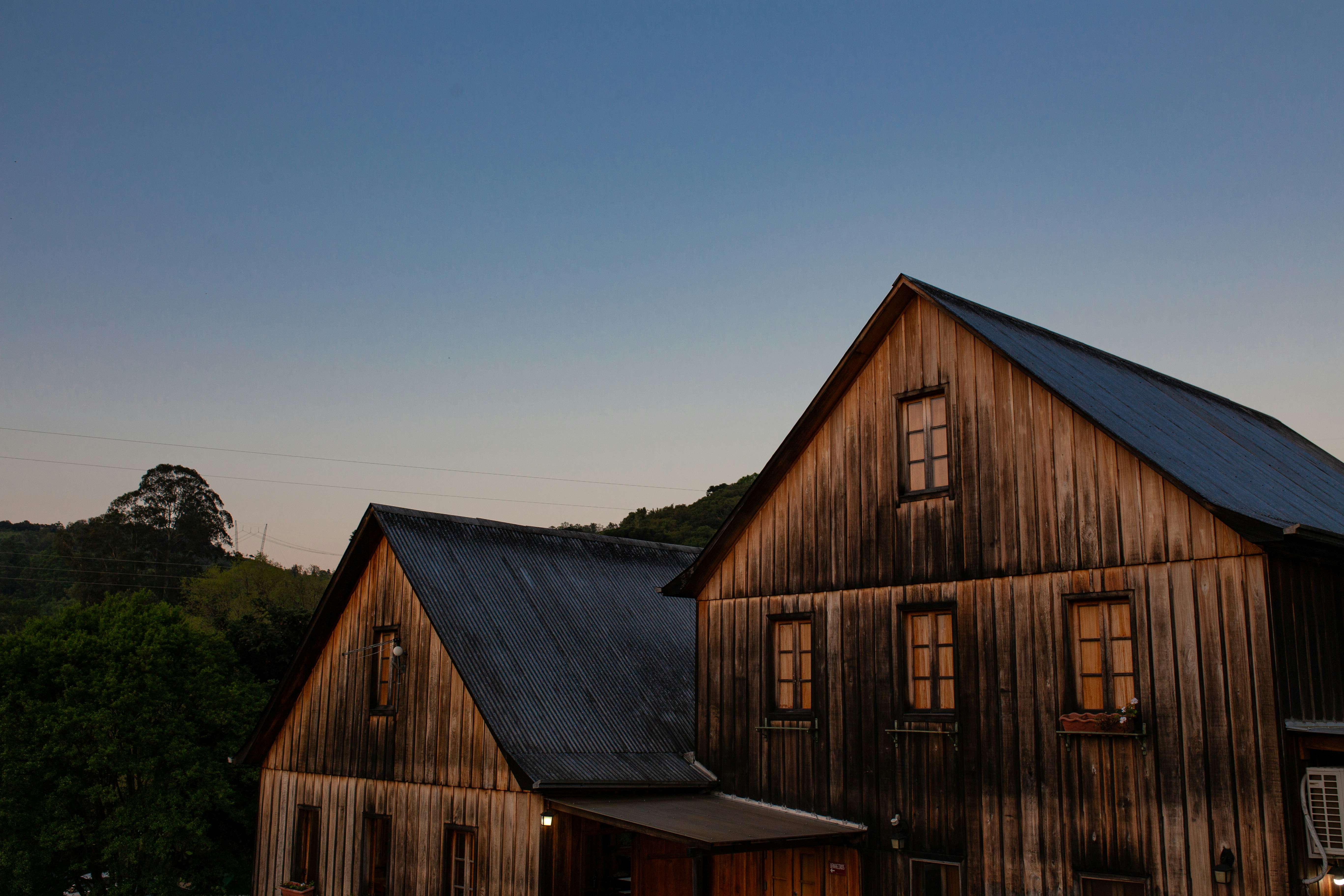 a large wooden building with a black roof