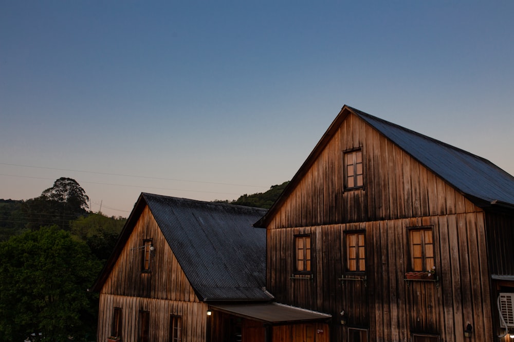 a large wooden building with a black roof