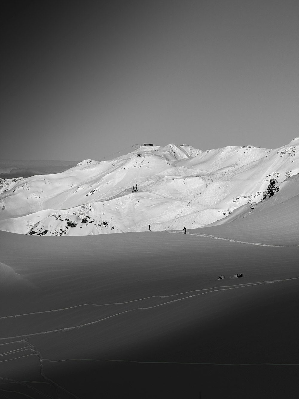 a black and white photo of a snow covered mountain