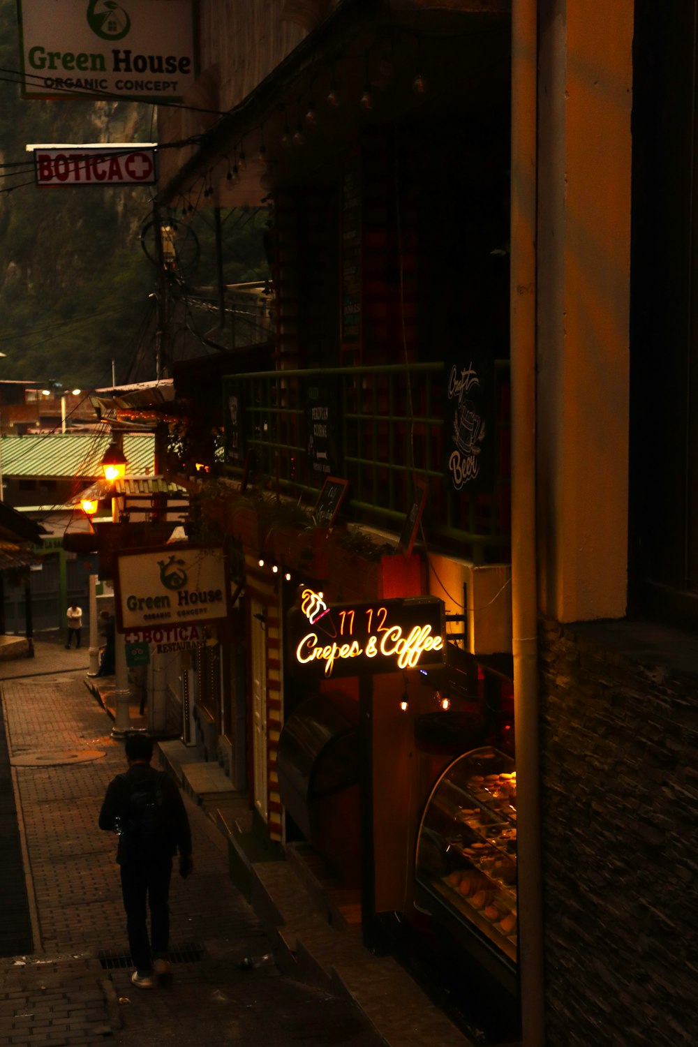 a person walking down a street at night