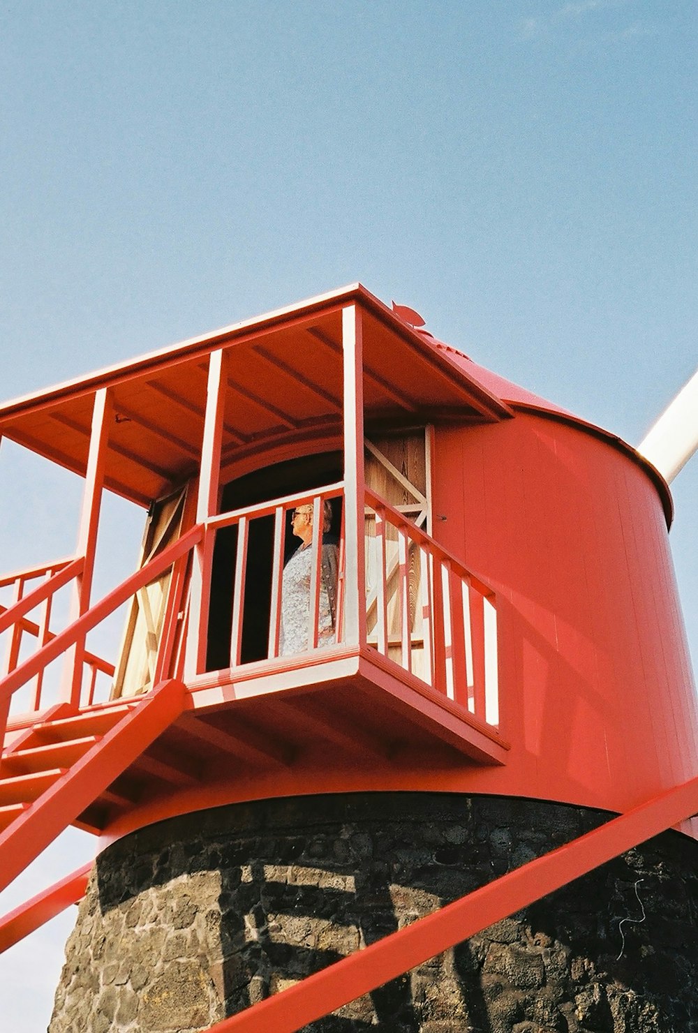 a man and a woman standing on a red tower