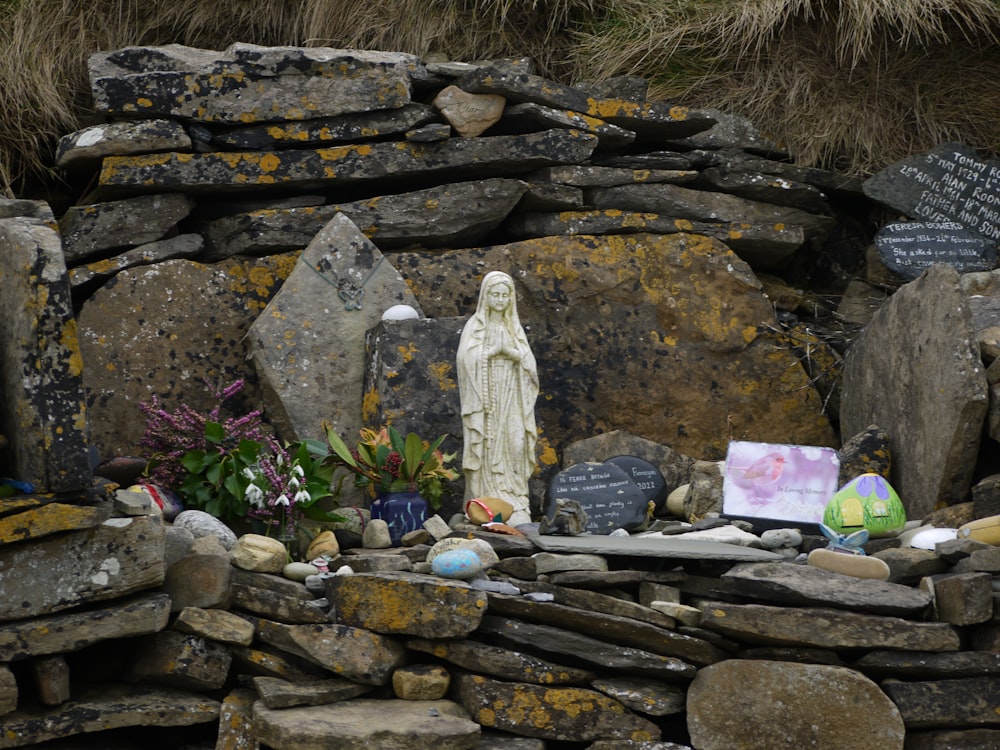 a statue of a person surrounded by rocks