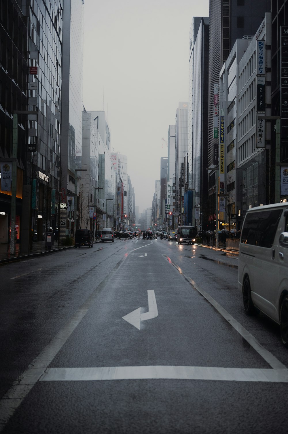 a city street with a white arrow painted on the road