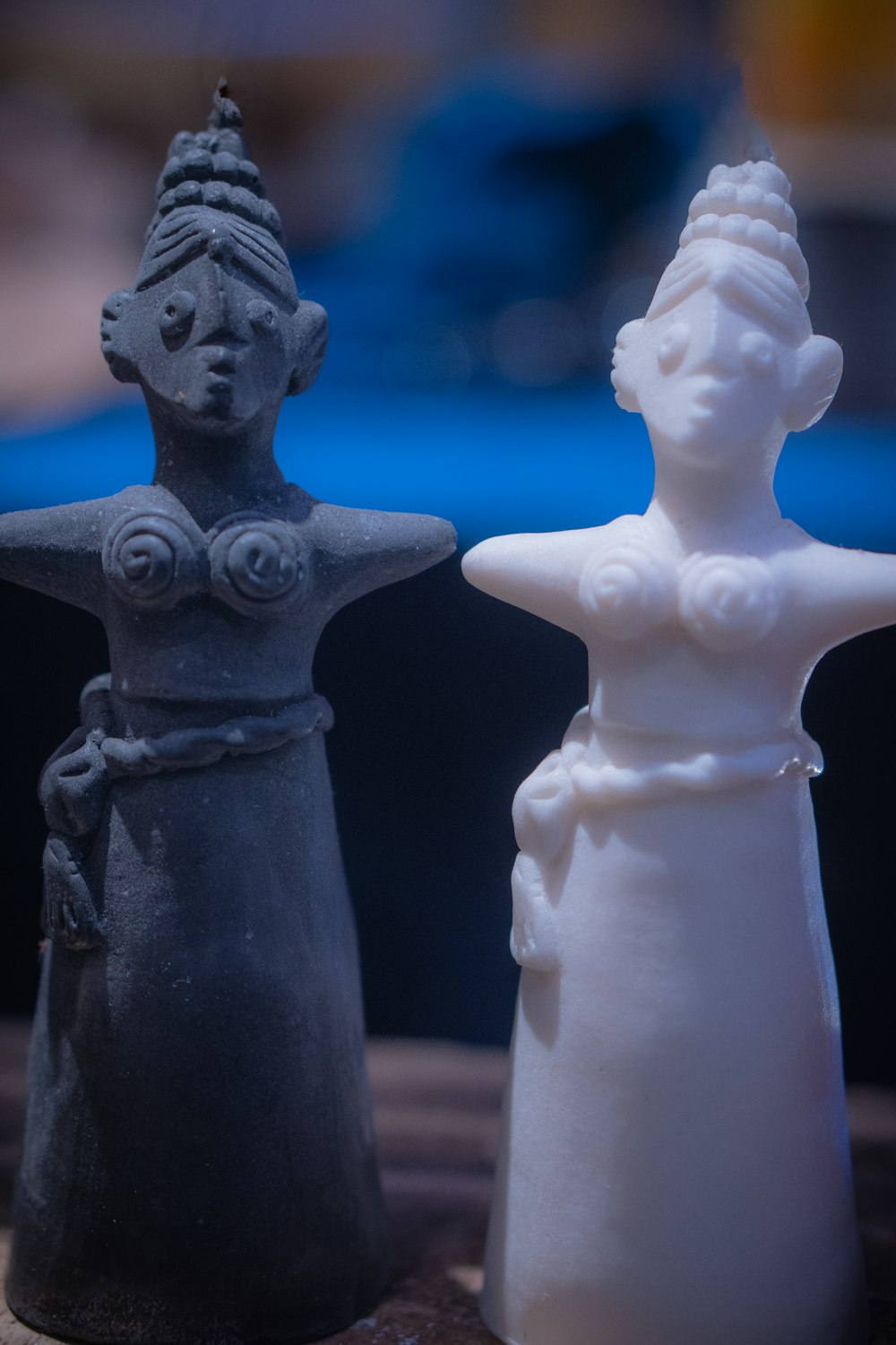 a close up of two small statues on a table