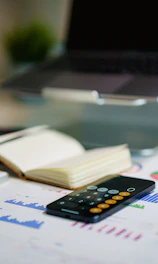 a remote control sitting on top of a table next to a book