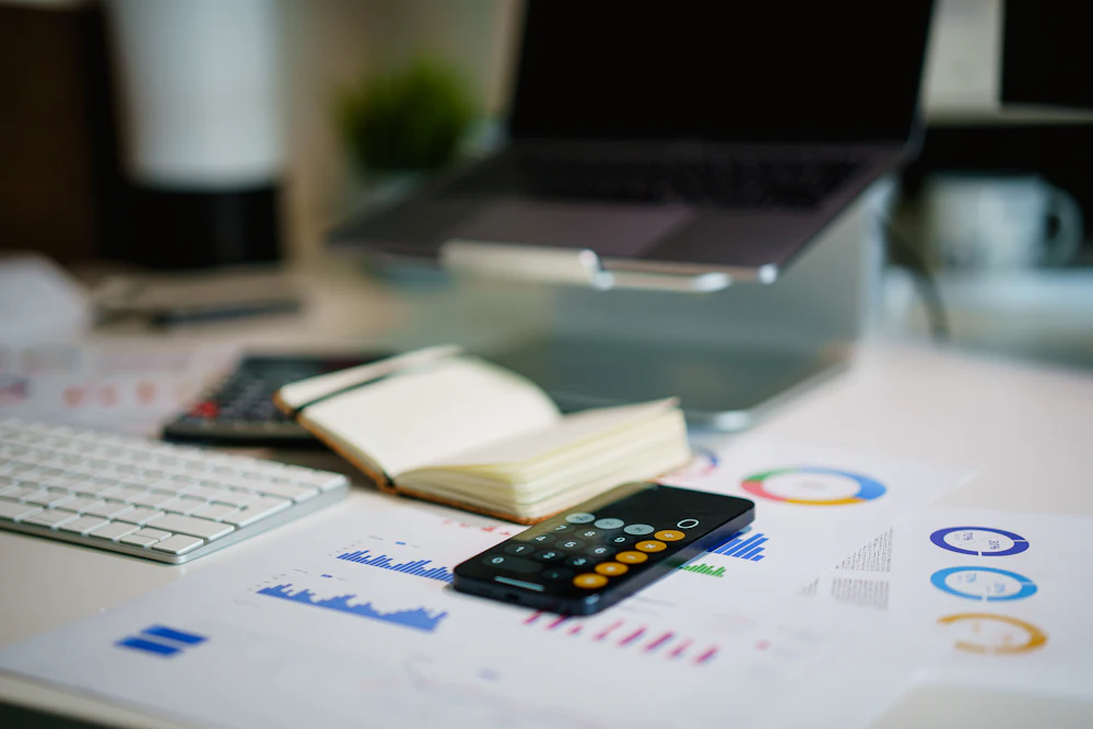 Desk with printed financial charts and reports