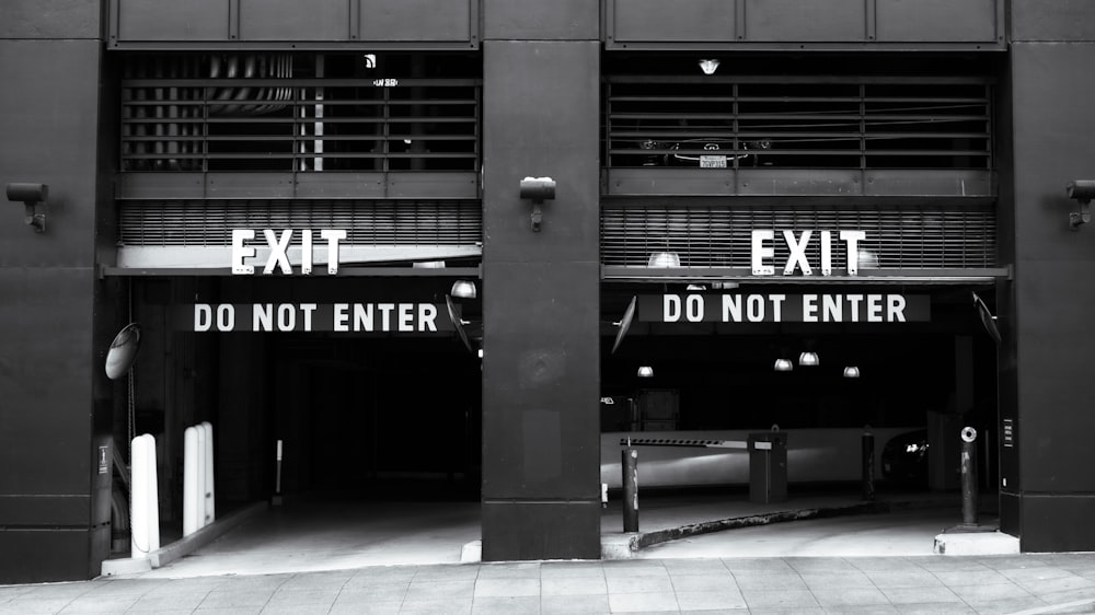 a black and white photo of an exit sign